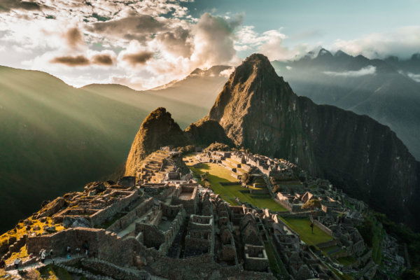 Sunrise over the ancient Incan citadel of Machu Picchu with Huayna Picchu peak, Peru