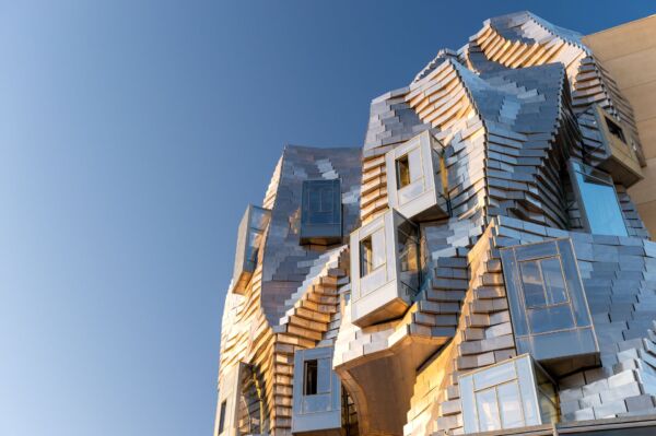 Frank Gehry's stainless steel LUMA Arles tower against a blue sky in Provence, France