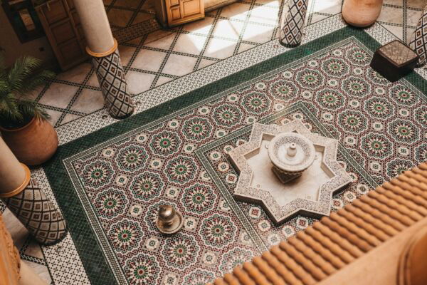 Aerial view of a star-shaped fountain and zellige-tiled courtyard in a riad in Meknes, Morocco