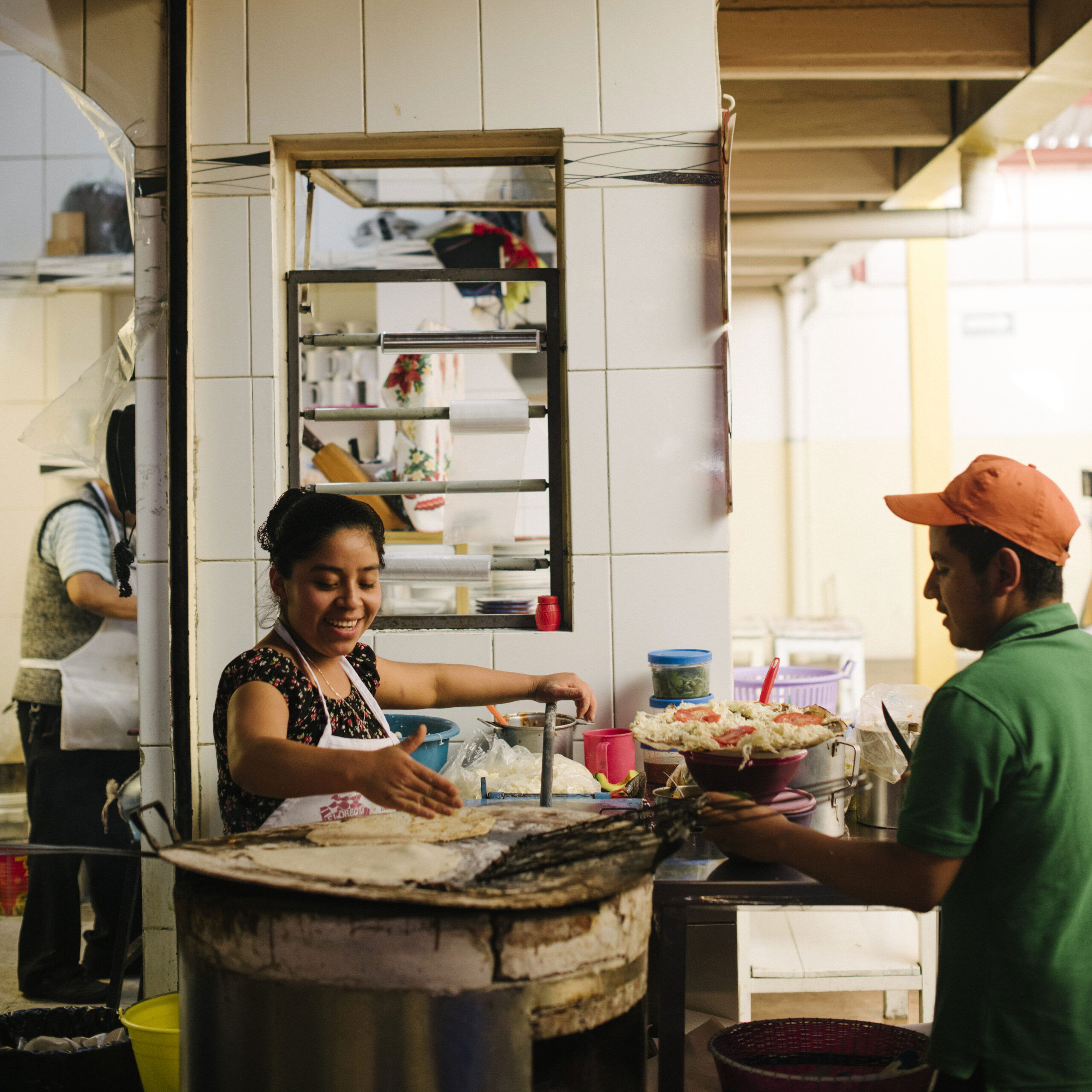 Mexico City street food vendor at a traditional fonda serving authentic Mexican cuisine in a vibrant market setting.